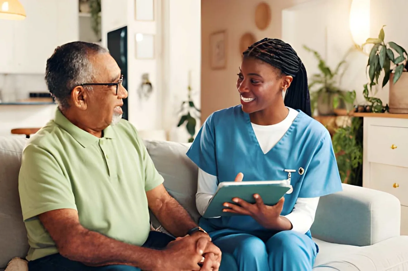 A caregiver and an older man discussing a plan together at home